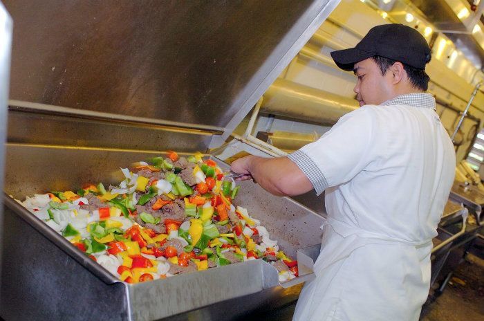 Food worker preparing food